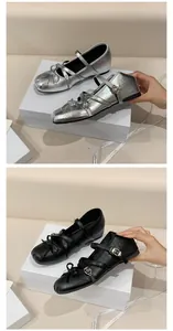 Close-up of French style Mary Jane ballet flats in silver and black with bow detail
