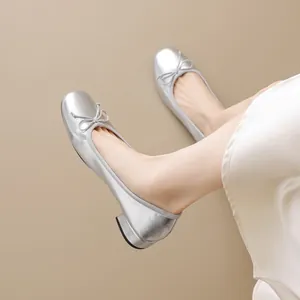 Elegant silver round toe ballet flats with bow detail and comfortable low block heel
