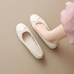 Elegant French style cream round toe ballet flats with bow detail and low block heel