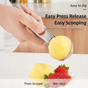 304 stainless steel ice cream scoop scooping a ball of yellow sorbet in kitchen