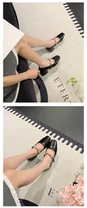 Elegant French style black Mary Jane chunky heels with shiny rhinestone strap on feet