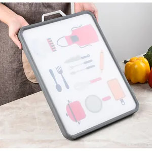 Detail showing the cartoon kitchenware pattern on a double-sided cutting board.
