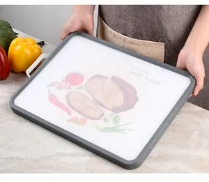 Detailed close-up of a double-sided 304 stainless steel and plastic cutting board with handle