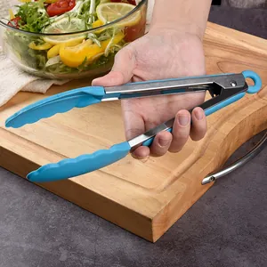 9-inch heat-resistant non-slip silicone food tongs held over a wooden cutting board