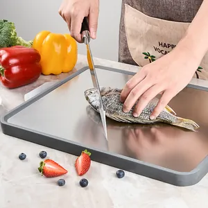 Professional double-sided 304 stainless steel cutting board shown in a kitchen setting