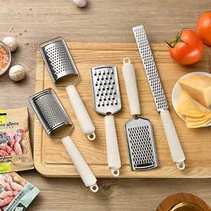 Premium set of 5 stainless steel cheese graters with cream fluted handles on wooden board