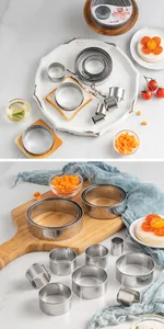 Detail view of a 14-piece stainless steel circular cookie cutter set on a wooden board