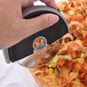 Stainless steel roller pizza cutter with ergonomic handle shown in use cutting pizza.