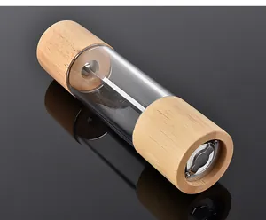 Detailed view of a manual pepper grinder featuring oak wood and clear acrylic body