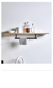 Wall-mounted wooden shelf with black metal towel rod and S-hooks in a bathroom setting