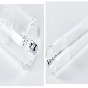 Close-up detail of transparent acrylic manual pepper grinder with adjustable knob