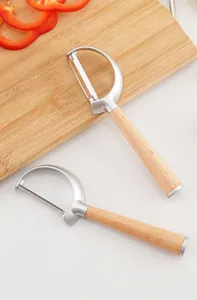 Detailed macro view of two zinc alloy vegetable peelers with smooth wooden handles