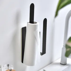 Black stainless steel wall-mounted kitchen paper towel holder in minimalist kitchen setting