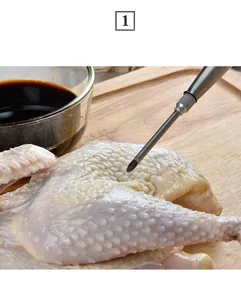 Stainless steel meat injector needle injecting marinade into raw poultry on a board