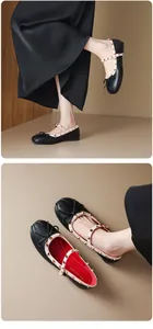 Detail of black Mary Jane flats with metal studs and elegant ribbon bow.