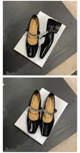 Top-down detail of black French Mary Jane pumps with luxury rhinestone strap