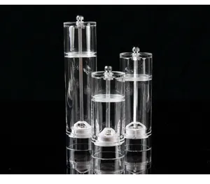 Set of three transparent acrylic manual pepper grinders in various heights on black