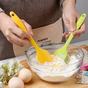 Durable small silicone spatula set for mixing baking ingredients in a glass bowl