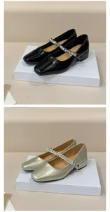 Detail view of French Mary Jane shoes with rhinestone straps in black and champagne colors
