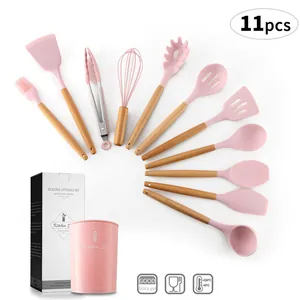 11-piece pink silicone kitchen utensil set with wooden handles and storage bucket