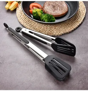 Close-up of stainless steel kitchen tongs with silicone tips and built-in stand