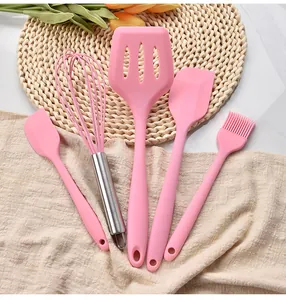 Detail view of a 5-piece pink silicone kitchen utensil set for baking and cooking.