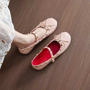 Elegant pink Mary Jane ballet flats with gold pyramid studs and cute bow detail