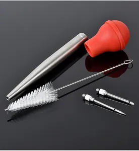 Detailed view of stainless steel turkey baster set with red silicone bulb and dual needles