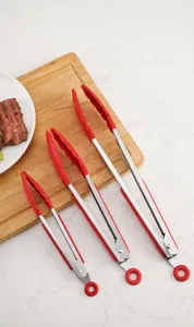 Set of three red silicone and stainless steel kitchen tongs for grilling and serving