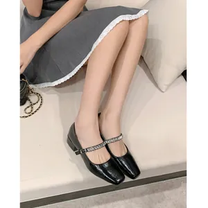 Elegant black patent leather Mary Jane pumps with sparkling rhinestone strap and block heel