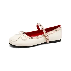 Elegant white Mary Jane ballet flats with rivet straps and bow detail on pleated toe box