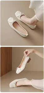 Close-up of elegant cream French ballet flats with bow detail and low block heel