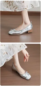 Elegant silver French ballet flats featuring a bow detail and comfortable chunky heel.