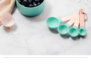 Detailed shot of mint green and rose gold measuring spoons on a marble surface