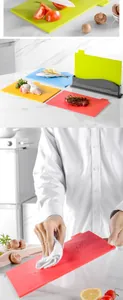 Detail showing a 4-piece color-coded plastic cutting board set with storage stand in kitchen