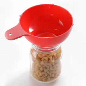 Red wide mouth plastic canning funnel for mason jars on a plain white background