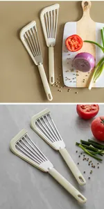 Stainless steel slotted fish spatula with heat-resistant silicone edge shown in use context.