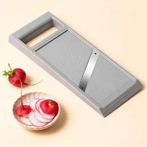 Grey handheld multifunctional vegetable slicer with freshly sliced red radishes