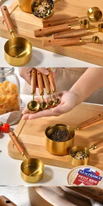 Detailed shot of an 8-piece gold stainless steel measuring set with wood handles
