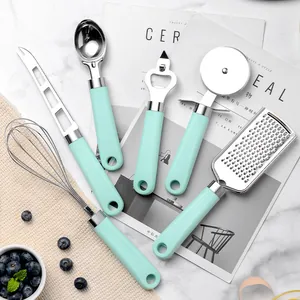 Mint green 6-piece stainless steel kitchen tool set including whisk and grater on marble