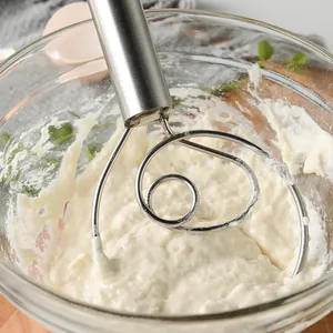 Professional Danish dough whisk stainless steel beater mixing flour in a glass bowl