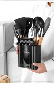 Detailed view of 12-piece black silicone kitchen utensil set with wooden handles