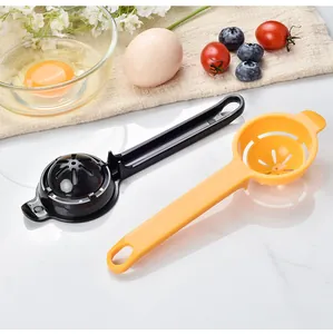 Detailed view of black and orange plastic egg white separators in a kitchen setting