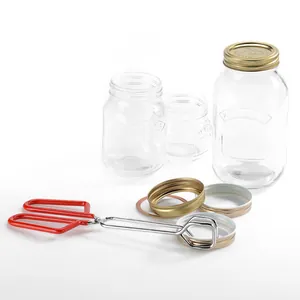 Professional canning tool set with red jar lifter tongs and assorted glass jars