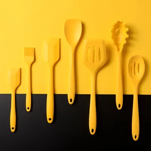 Vibrant yellow silicone kitchen utensil set displayed on a modern contrast background