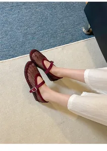 Elegant wine red mesh Mary Jane flats with sparkling rhinestone details worn on feet