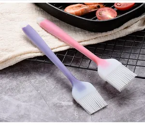 Detail view of pink and purple gradient silicone basting brushes for BBQ and cooking.