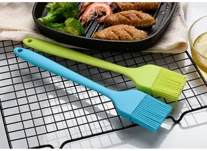 Detailed macro view of large blue and green silicone basting brushes for BBQ and baking