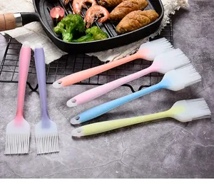 Colorful silicone basting brushes for BBQ and baking shown in a realistic kitchen setting
