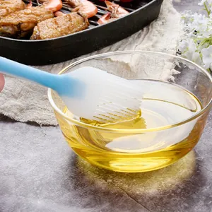Professional blue silicone oil brush for BBQ and baking dipping in clear oil bowl